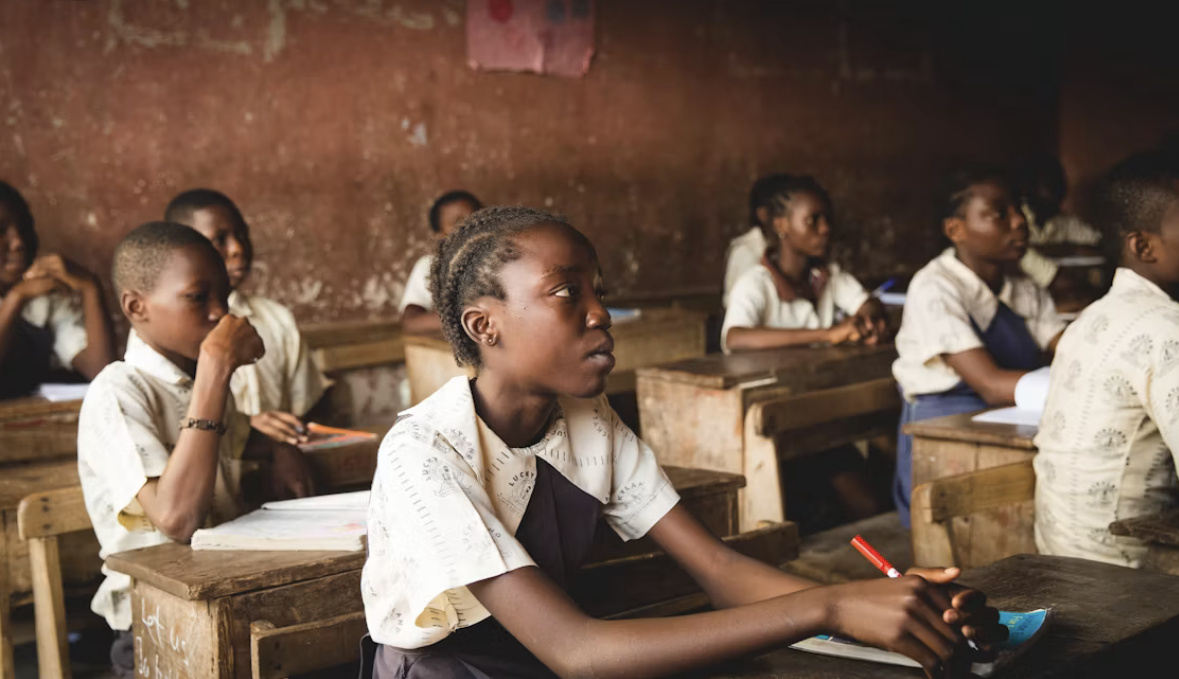 A pupil at The Bevan Morris School writing carefully in her exercise book